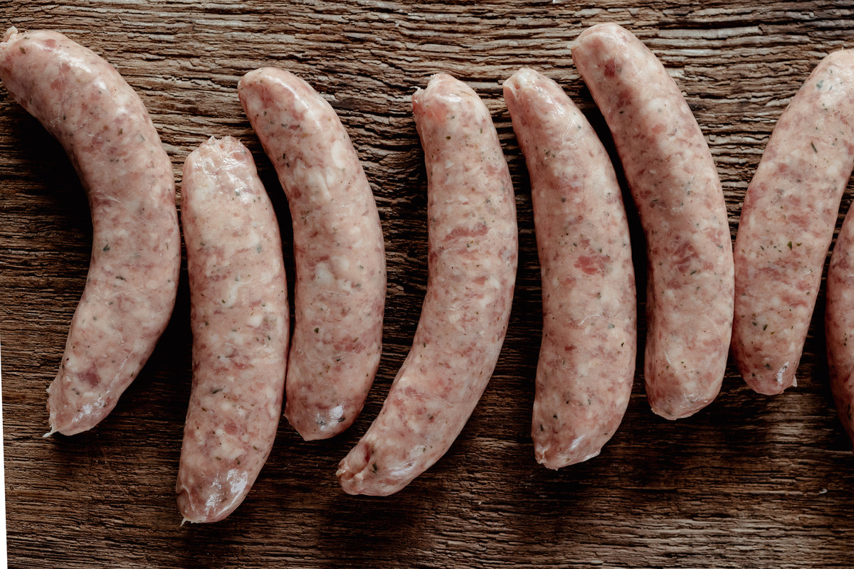 Raw sausages arranged on a wooden surface